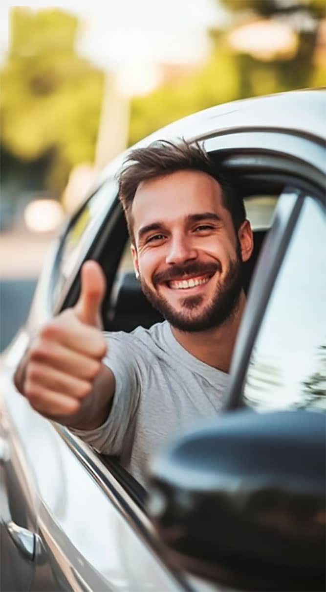 Happy learner holding car keys after passing a driving lesson